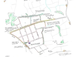 Hand drawn planning sketch map showing field boundaries, roads, and landscape features with coloured lines and handwritten notes, representing a site layout proposal.